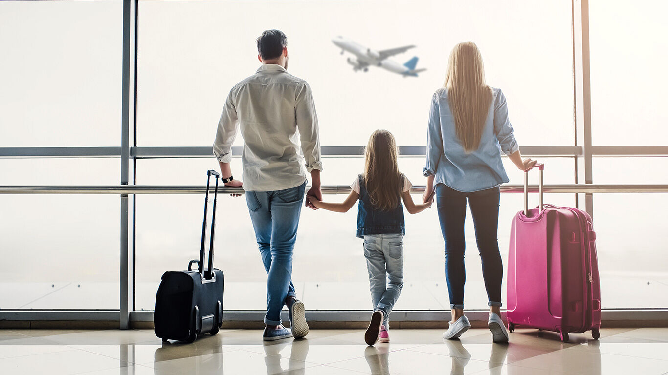 Family strolling through airport